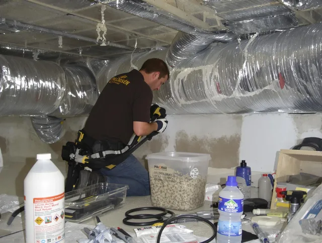 Whitman Air Duct Cleaning specialist performing professional mold removal from air ducts in Whitman