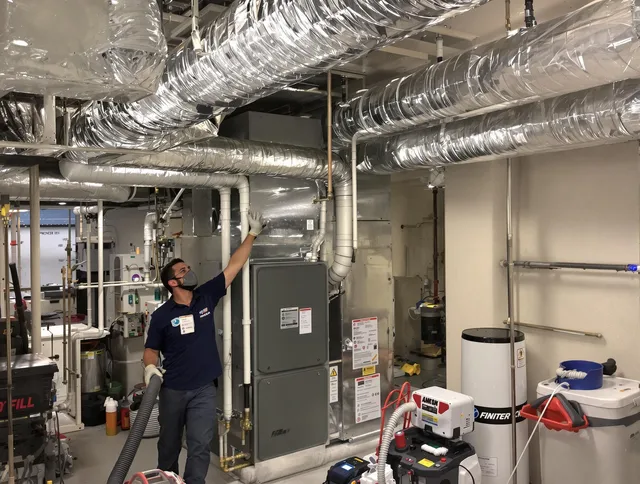 Whitman Air Duct Cleaning specialist performing thorough furnace duct cleaning in a Whitman residence