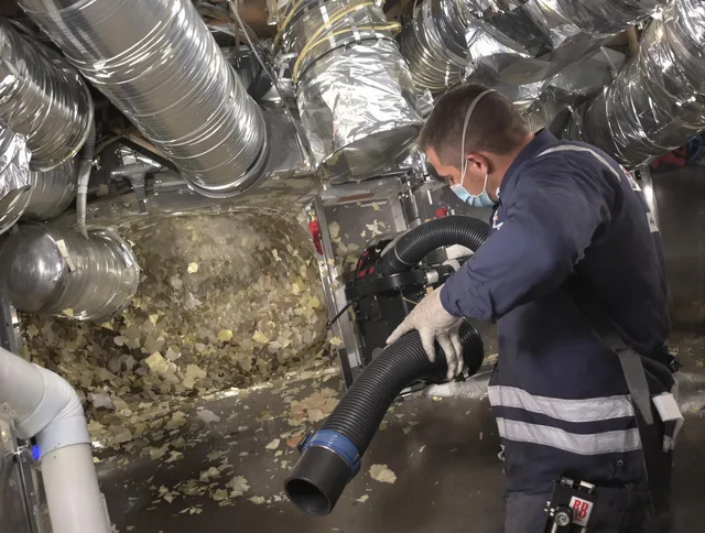 Whitman Air Duct Cleaning specialist operating negative pressure cleaning equipment for thorough duct maintenance in Whitman