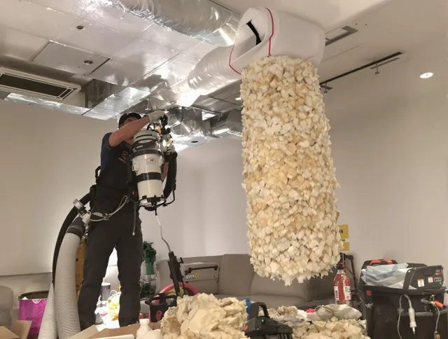Whitman Air Duct Cleaning technician performing precision vacuum insulation removal in a residential property in Whitman