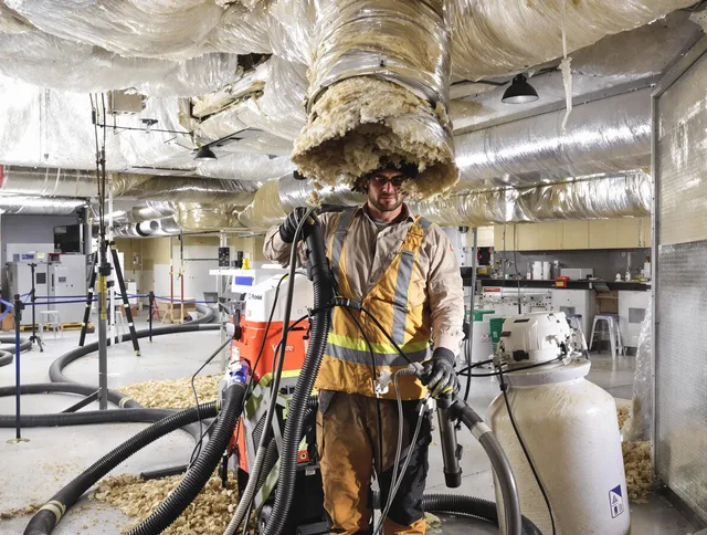 Professional vacuum insulation removal by Whitman Air Duct Cleaning expert in Whitman